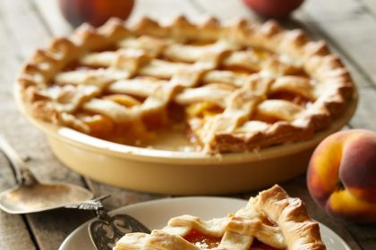 Freshly baked peach pie with golden crust and sweet peach filling