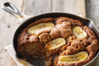 Freshly baked banana bread cobbler served warm in a dish with a scoop of vanilla ice cream