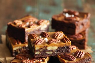 A delicious stack of pecan pie brownies with a rich chocolate base and caramelized pecan topping.