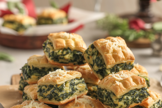Golden-brown spinach puffs on a plate, filled with creamy spinach and cheese mixture